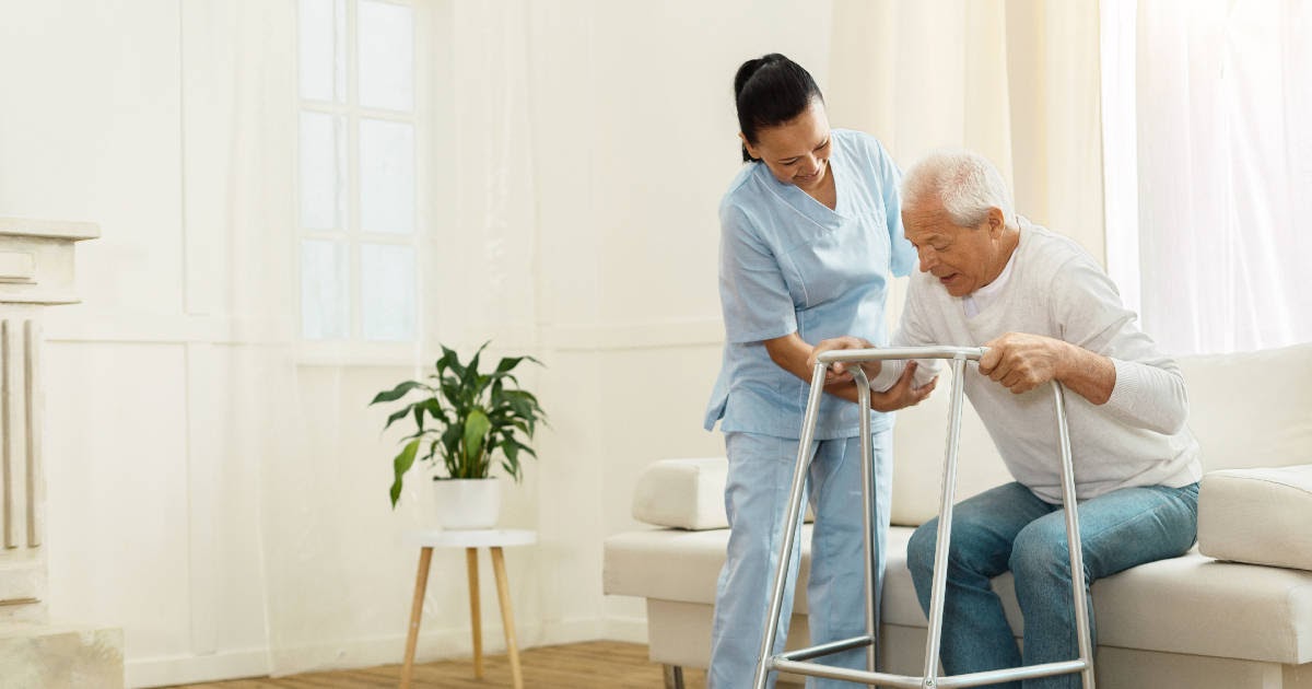 female care taker helping elderly man